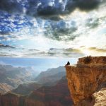Man sitting on the edge of the Grand Canyon